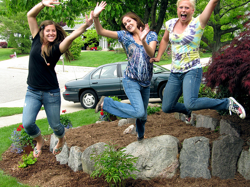 happy teen girls jumping